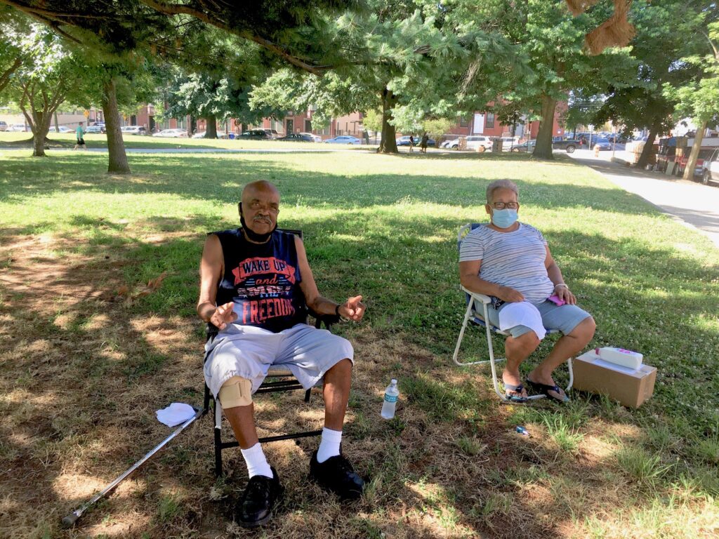 2020 07 02-c jaramillo-gilberto padilla carmen roman-philadelphia norris square-city heat plan Gilberto Padilla, 78, and Carmen Román, 70, set up their chairs in the shade in Norris Square to beat the heat. (Catalina Jaramillo/WHYY)