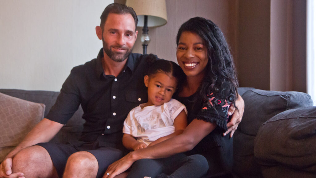 2020 7 10 k paynter gsouth philly family-3 Aria Valentina Riso in between her mom, Chelsie DeSouza and dad, Vincent Riso at their home in South Philadelphia. (Kimberly Paynter/WHYY)
