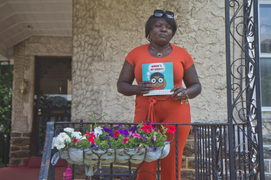 2020 7 9 k paynter gun violence prevention_-4 Kimberly Kamara holds a children’s book she wrote to help explain to her grandson how his father’s life ended tragically. (Kimberly Paynter/WHYY)
