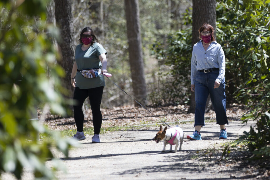 Virus Outbreak New Jersey People wearing a protective face coverings hike at Shark River Park in Wall Township, N.J., Saturday, May 2, 2020. (AP Photo/Matt Rourke)