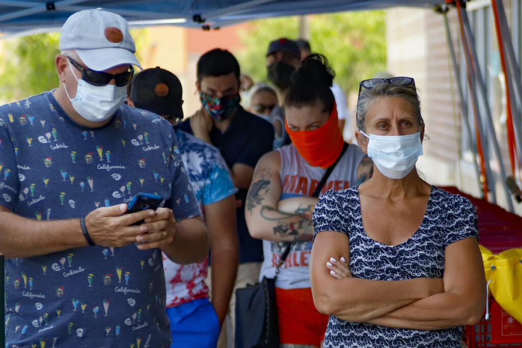 Virus Outbreak Pennsylvania Masks People waiting in line to enter a grocery store wear protective masks, Friday, July 3, 2020, in McCandless, Pa. Gov. Tom Wolf's more expansive mask order issued last week as the coronavirus shows new signs of life in Pennsylvania has been met with hostility from Republicans objecting to the Democrat's use of power or even to wearing a mask itself. (AP Photo/Keith Srakocic)