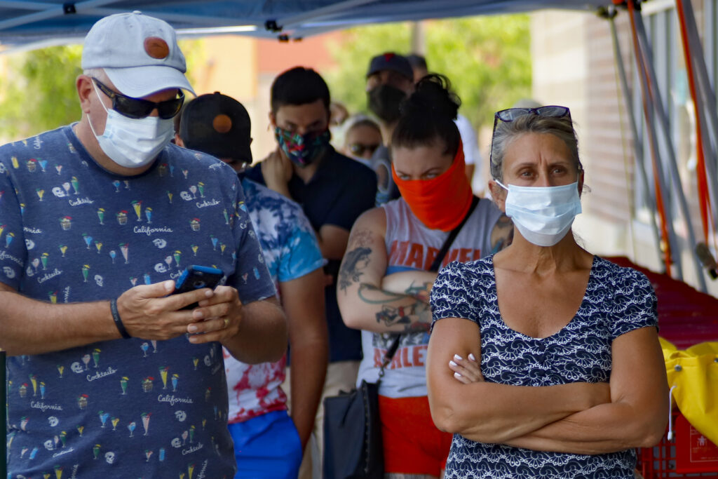 Virus Outbreak Pennsylvania Masks People waiting in line to enter a grocery store wear COVID-19 protective masks