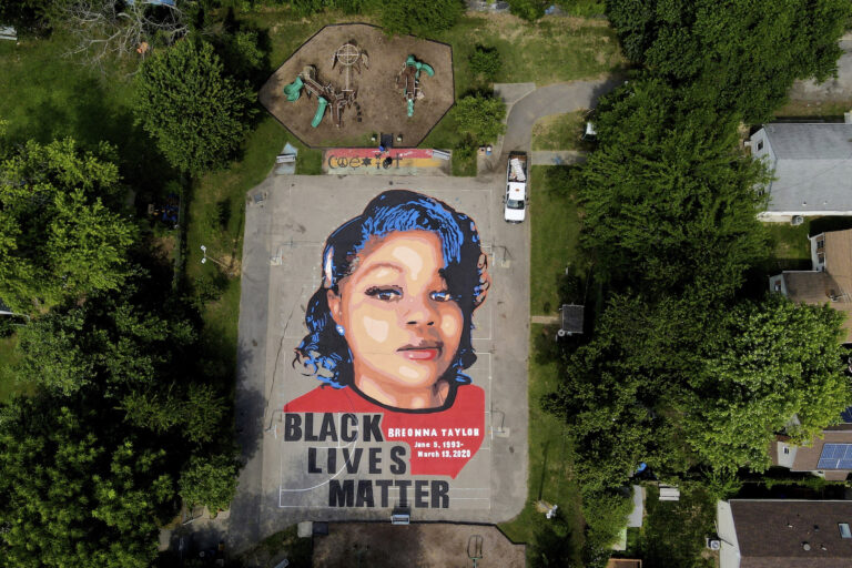 A ground mural depicting a portrait of Breonna Taylor is seen at Chambers Park, Monday, July 6, 2020, in Annapolis, Md. The mural honors Taylor, a 26-year old Black woman who was fatally shot by police in her Louisville, Kentucky, apartment. The artwork was a team effort by the Banneker-Douglass Museum, the Maryland Commission on African American History and Culture, and Future History Now, a youth organization that focuses on mural projects. (AP Photo/Julio Cortez)