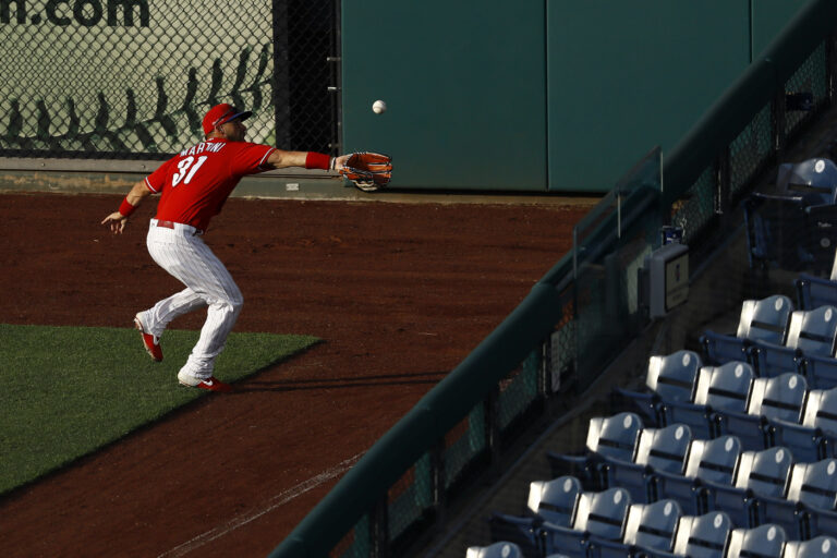 Philadelphia Phillies' Nick Martini catches a fly ball hit by Josh Harrison during an intrasquad baseball game Tuesday, July 14, 2020, in Philadelphia. (AP Photo/Matt Slocum)