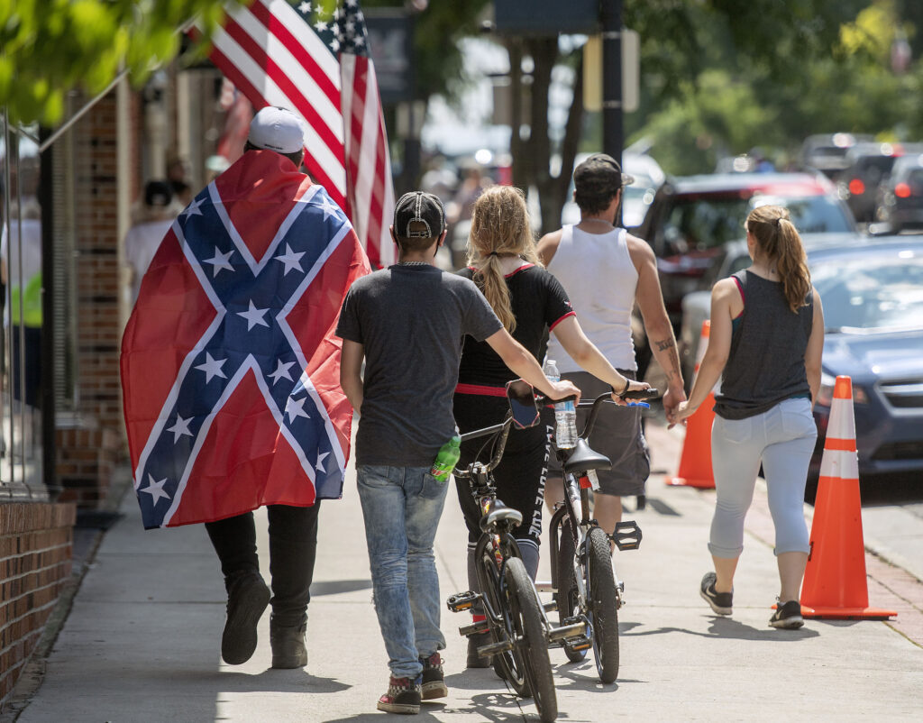 Confederate Flag Pentagon A young man wears a Confederate flag while walking with friends in Marion, VA Friday afternoon. (AP Photo/Andre Teague, Bristol Herald Courier)