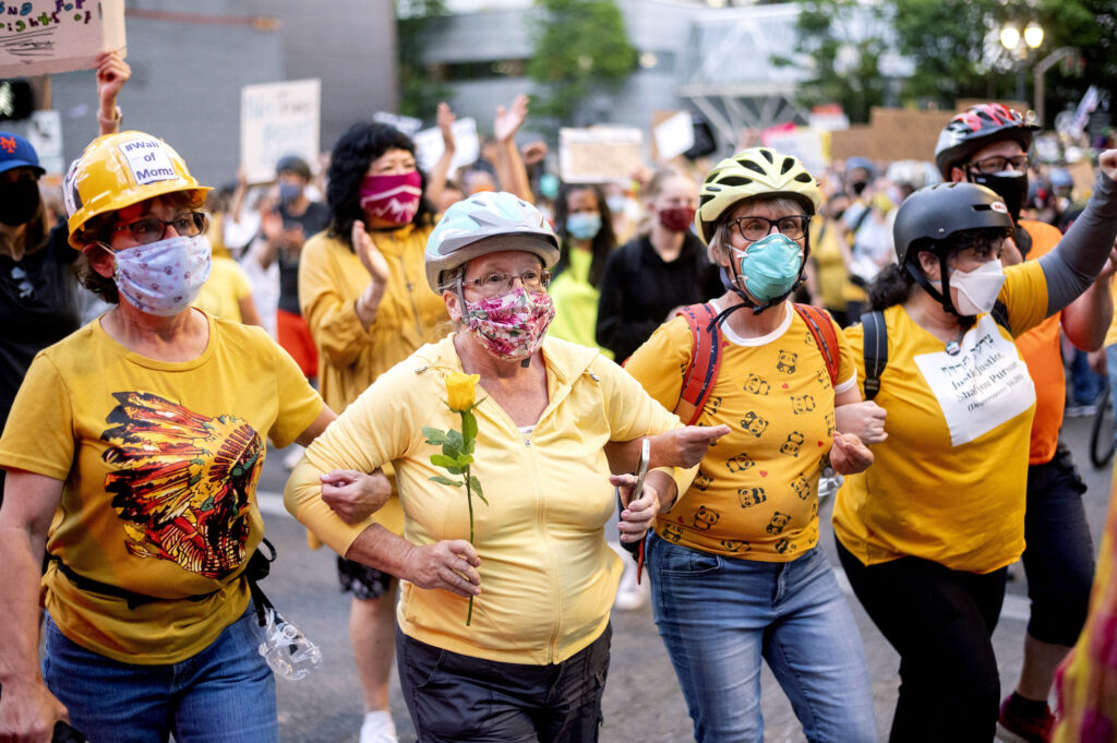 Racial Injustice Portland Norma Lewis holds a flower while forming a