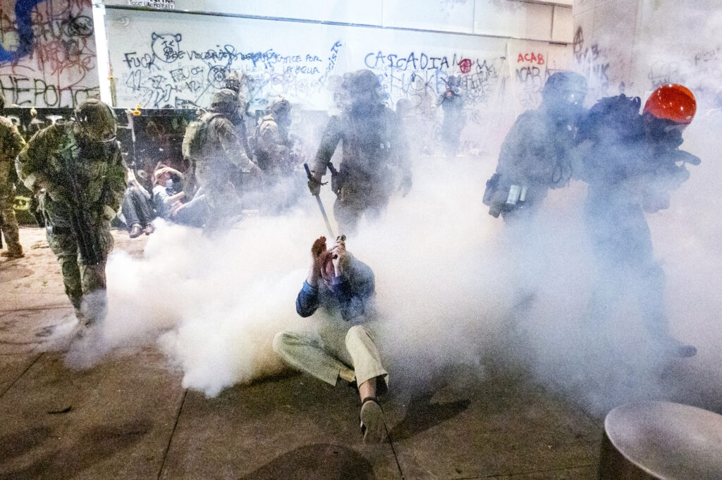 APTOPIX Racial Injustice Portland Federal officers use chemical irritants and crowd control munitions to disperse Black Lives Matter protesters outside the Mark O. Hatfield United States Courthouse on Wednesday, July 22, 2020, in Portland, Ore. (AP Photo/Noah Berger)