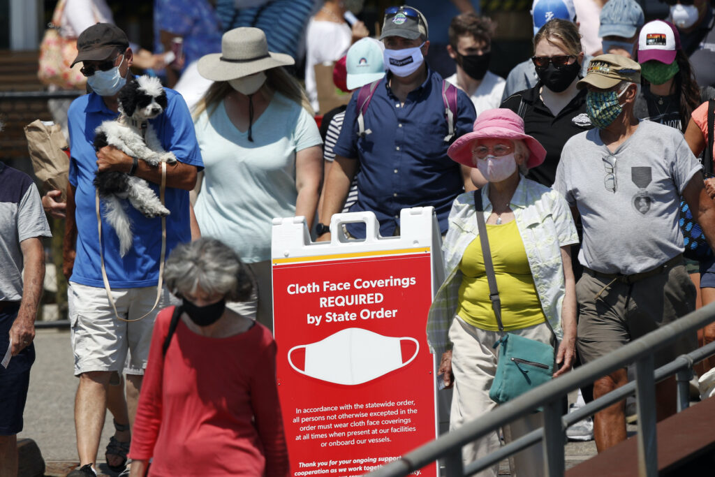Virus Outbreak Maine Passengers boards a Casco Bay Lines ferry bound for Peaks Island, Thursday, July 30, 2020, in Portland, Maine. (AP Photo/Robert F. Bukaty)
