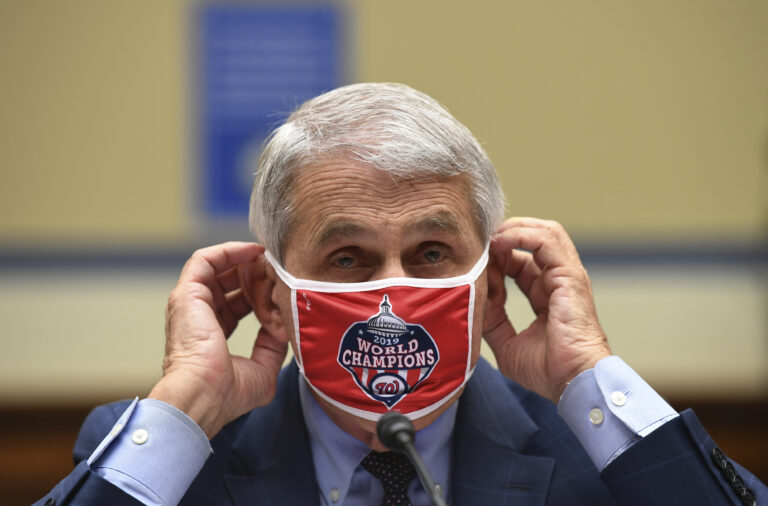 Dr. Anthony Fauci, director of the National Institute for Allergy and Infectious Diseases, adjusts his face mask during a House Subcommittee on the Coronavirus crisis hearing, Friday, July 31, 2020 on 
Capitol Hill in Washington.  (Kevin Dietsch/Pool via AP)