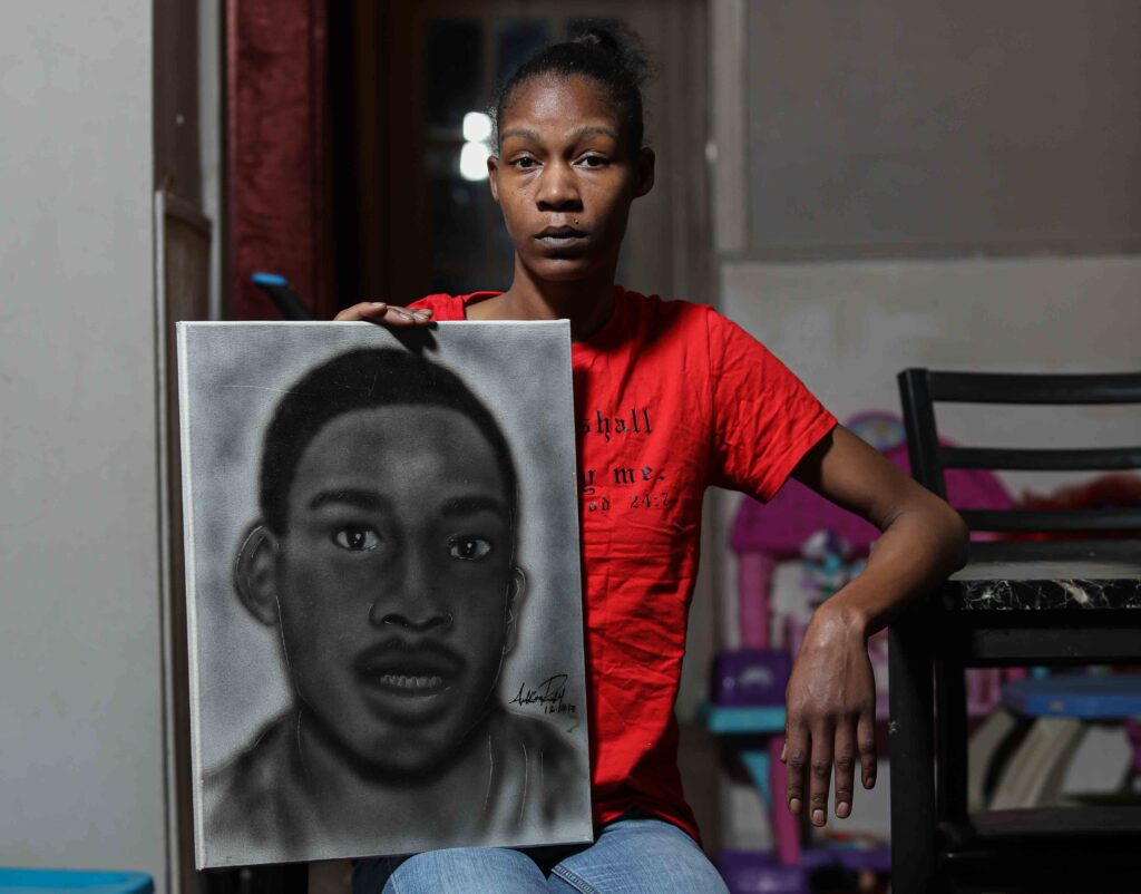 News 2020 – FEB 06 – Keandra McDole, the sister of Jeremy McDole, a wheelchair bound man who was shot to death by police Keandra McDole stands with a sketch of her brother, Jeremy