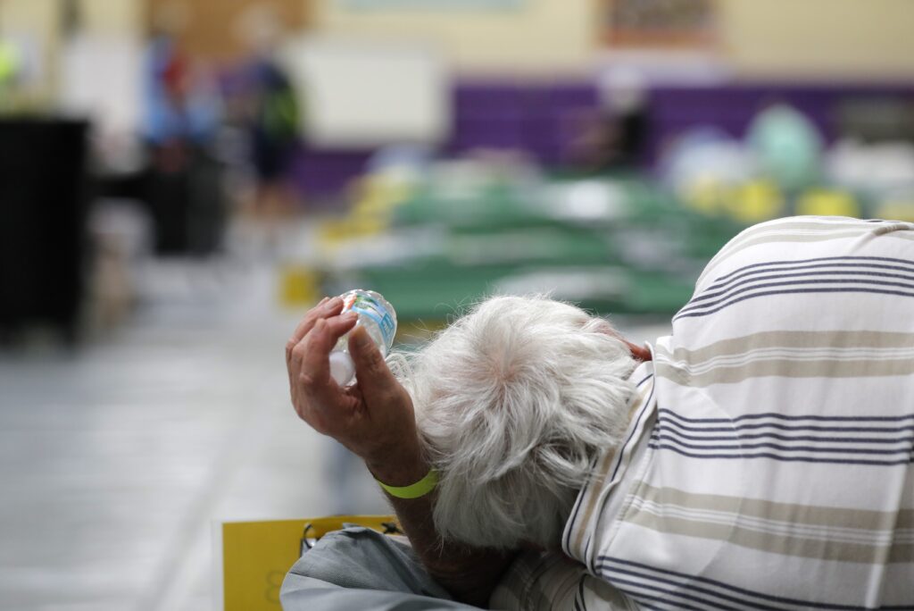 An evacuee lies on a cot at an evacuation shelter for people with disabilities in Stuart, Fla., in preparation for Hurricane Dorian on Sept. 1, 2019. Now, with the pandemic raging, officials across the South are trying to adjust their evacuation and shelter plans. An evacuee lies on a cot at an evacuation shelter for people with disabilities in Stuart, Fla., in preparation for Hurricane Dorian on Sept. 1, 2019. Now, with the pandemic raging, officials across the South are trying to adjust their evacuation and shelter plans. (Gerald Herbert/AP Photo)