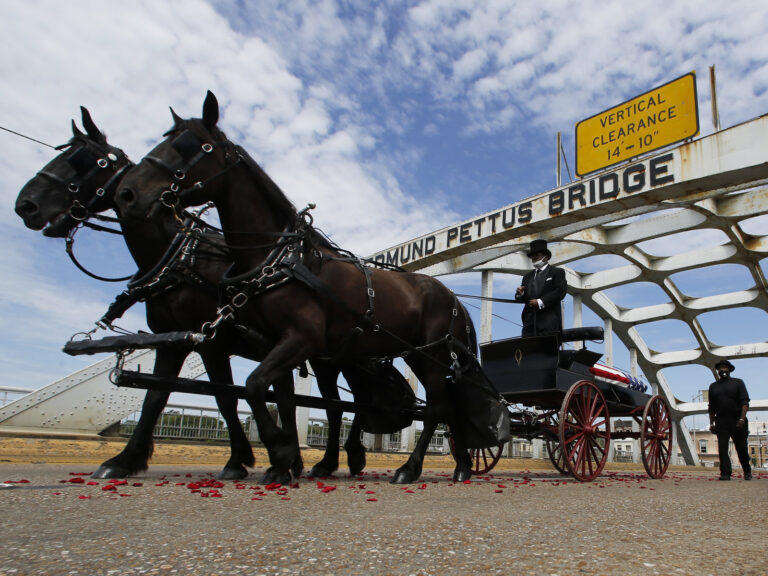 The casket of Rep. John Lewis moves over the Edmund Pettus Bridge
