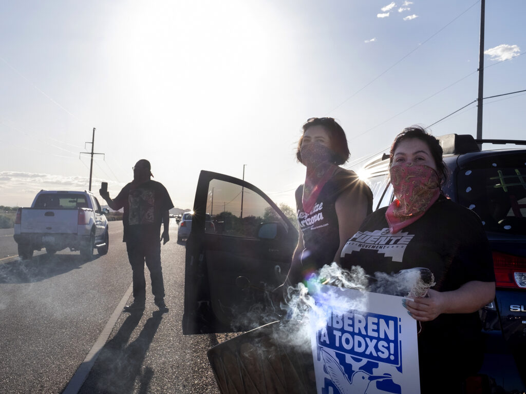 Demonstrators stand along the road in front of the La Palma Correctional Center in Eloy on April 10, 2020. The event was one of several car rallies calling for the release of immigrants detained at the ICE facility during COVID-19. Demonstrators stand along the road in front of the La Palma Correctional Center in Eloy on April 10, 2020. The event was one of several car rallies calling for the release of immigrants detained at the ICE facility during COVID-19.