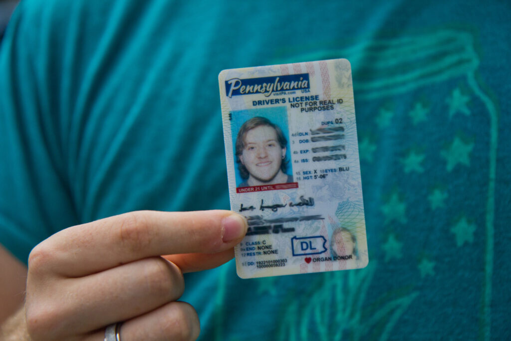 blurredxgender Finn Nahill holds a new drivers license, which uses the gender-neutral designation