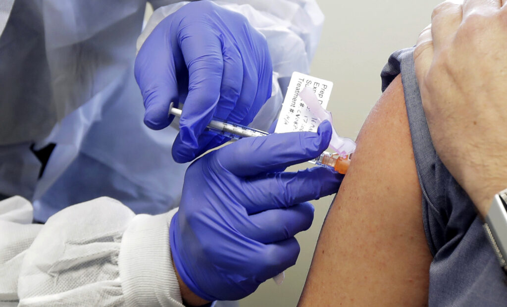 A patient receives a shot in a clinical trial for a potential coronavirus vaccine. U.S. intelligence officials say Russian hackers are attempting to break into U.S. health care organizations working on a vaccine. A patient receives a shot in a clinical trial for a potential coronavirus vaccine. U.S. intelligence officials say Russian hackers are attempting to break into U.S. health care organizations working on a vaccine.