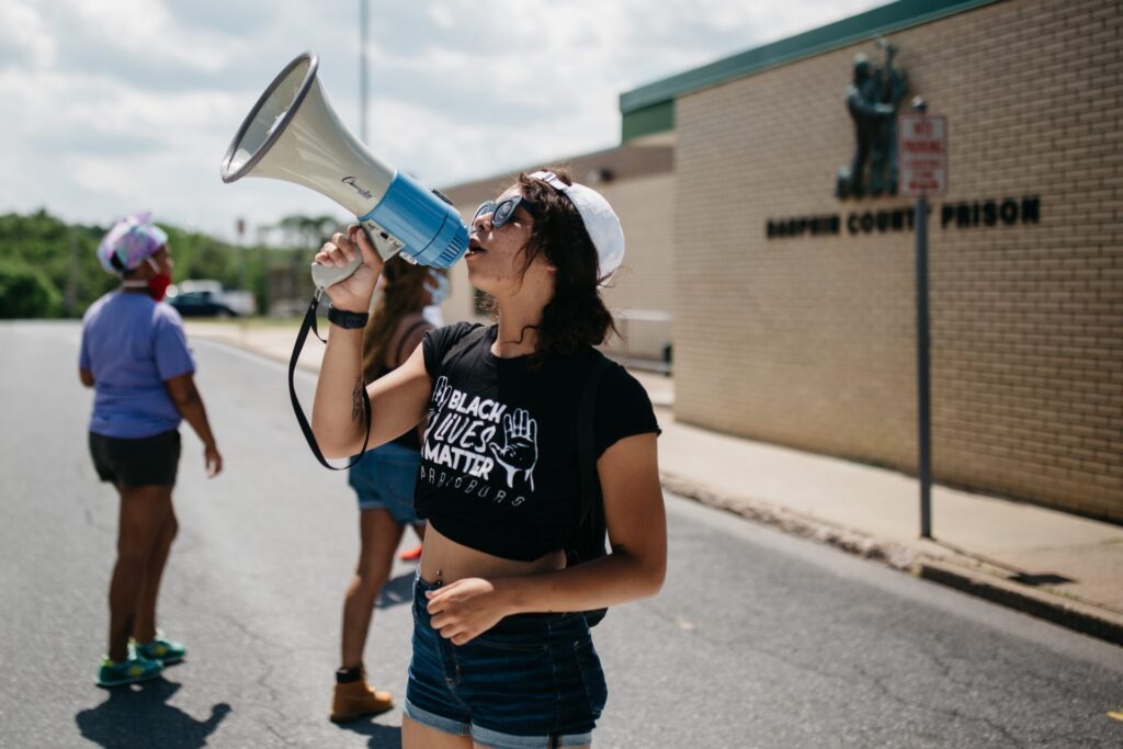 dauphincountyprison-1-1-1920×1280 A protester with Black Lives Matter Harrisburg takes part in a protest outside Dauphin County Prison on June 30, 2020. Inmates inside the facility could be heard banging on the windows and holding up signs pleading for help. (Kate Landis/PA Post)