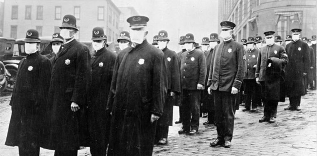 file-20200706-3943-5gsic4 Policemen in Seattle, Washington, wearing masks made by the Red Cross, during the influenza pandemic, December 1918. (National Archives)