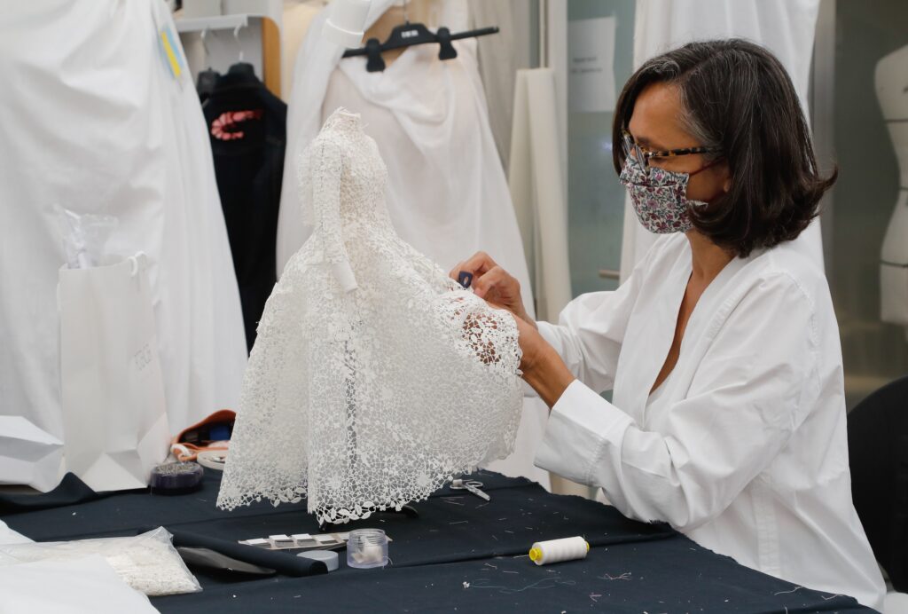 An employee sews a miniature dress in Dior’s sewing workshop in Paris on July 4. This year Dior created a miniature collection for its haute couture show and presented it as a film. An employee sews a miniature dress in Dior's sewing workshop in Paris on July 4. This year Dior created a miniature collection for its haute couture show and presented it as a film. (Francois Guillot/AFP via Getty Images)