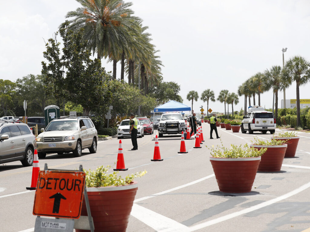 Cars line up for drive-through COVID-19 testing at the Duke Energy Center for the Arts Mahaffey Theater in St. Petersburg, Fla. The state reported a record-breaking 15,299 new cases on Sunday. Cars line up for drive-through COVID-19 testing at the Duke Energy Center for the Arts Mahaffey Theater in St. Petersburg, Fla. The state reported a record-breaking 15,299 new cases on Sunday.