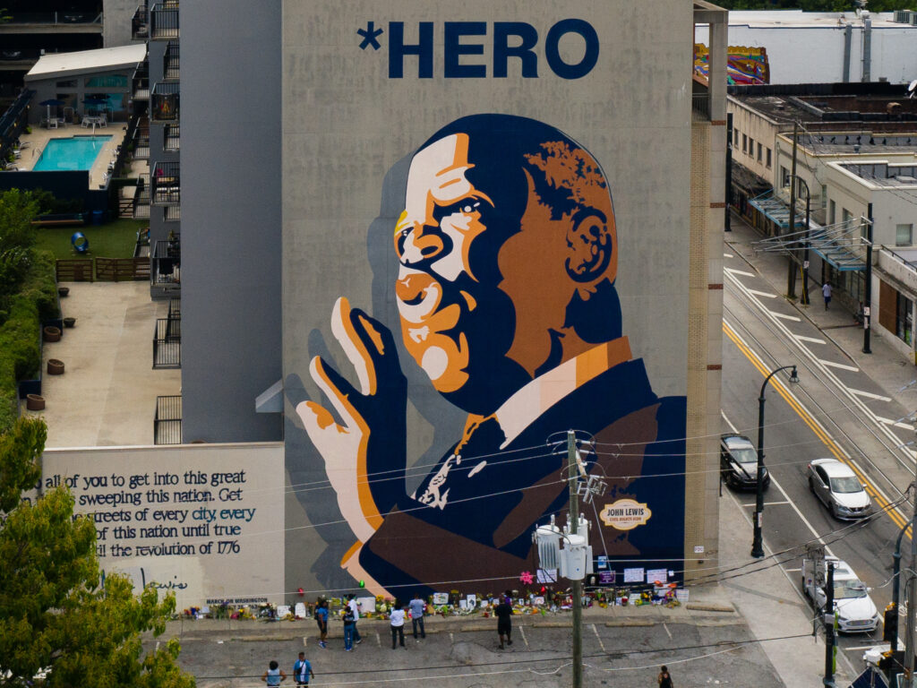 Mourners pay their respects at a mural of Rep. John Lewis painted on a building in Atlanta. The civil rights icon and congressman died on Friday. Mourners pay their respects at a mural of Rep. John Lewis painted on a building in Atlanta. The civil rights icon and congressman died on Friday.