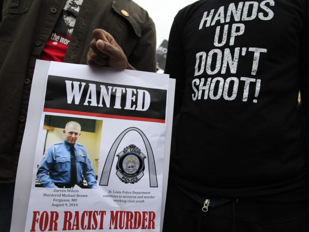 Demonstrators hold a sign in St. Louis, Mo., following the 2014 shooting death of 18-year-old Michael Brown. Demonstrators hold a sign in St. Louis, Mo., following the 2014 shooting death of 18-year-old Michael Brown. (Joshua Lott/AFP via Getty Images)