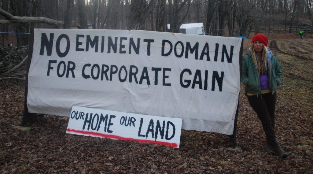 holleran-march-1-2016-016-e1555021260471-1920×1066 Megan Holleran stands by a sign on her family's land, March, 2016. The Hollerans lost their court battle to save their maple trees from eminent domain seizure. The trees were cut to make way for the Constitution Pipeline, which had been stalled amid legal battles until Williams withdrew the project in February. (Jon Hurdle / StateImpact PA)