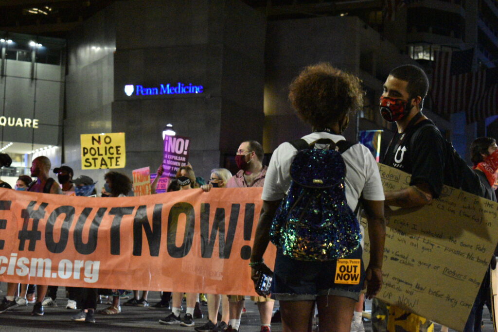 Jordan Johnson speaks to another protester at a demonstration in Philadelphia against federal law enforcement presence in Portland, Oregon. (Brett Sholtis/WITF)