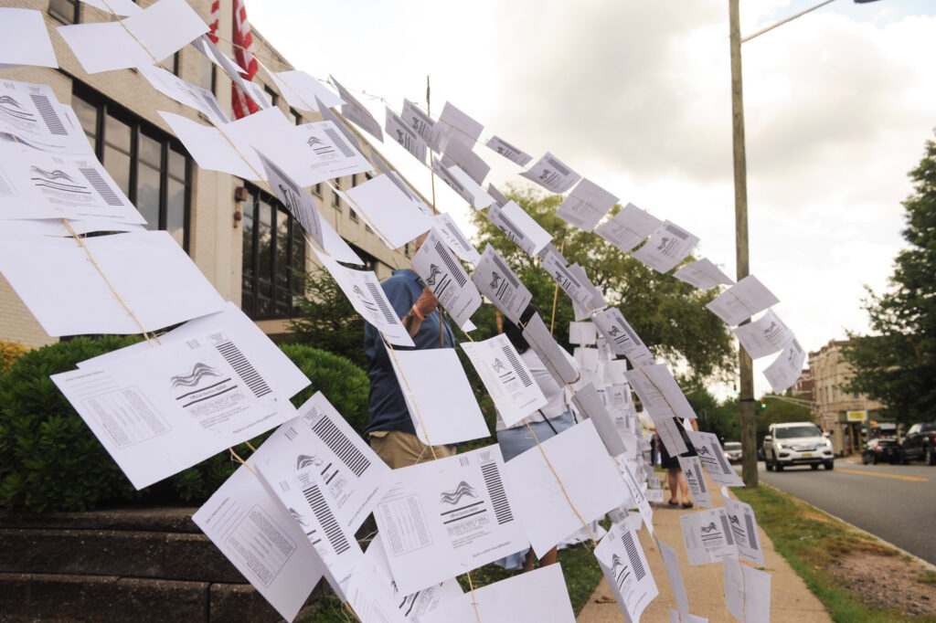A rally outside the Montclair, N.J., town hall on July 1. Protesters hung 1,101 absentee ballots to represent the number of votes that weren’t counted in a mayoral election that was decided by just 195 votes. A rally outside the Montclair, N.J., town hall on July 1. Protesters hung 1,101 absentee ballots to represent the number of votes that weren't counted in a mayoral election that was decided by just 195 votes.