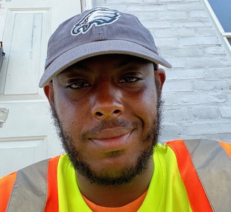 lead for trash Terrill Haigler aka @_yafavtrashman smiles during a shift as a city sanitation worker. (Courtesy of Terrill Haigler)