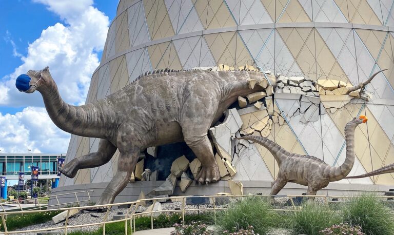 A life-sized dinosaur family wearing masks bursts from the walls of The Children's Museum of Indianapolis, the largest children's museum in the world.