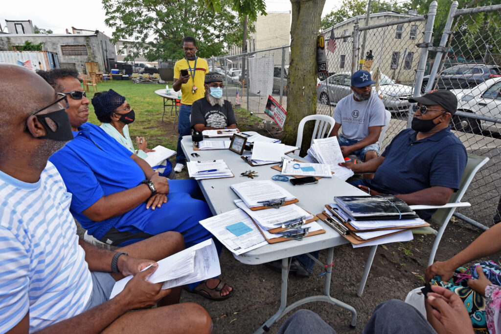 04 (1) Residents meet in South Camden on August 6 to compile petitions they've circulated and plan strategy in an effort to return nonpartisan voting to the city. (Photo by April Saul for WHYY)