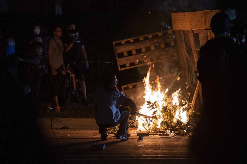A protester in Kenosha lights some debris on fire on Aug. 26, 2020. A protester in Kenosha lights some debris on fire on Aug. 26, 2020. (Angela Major/WPR)