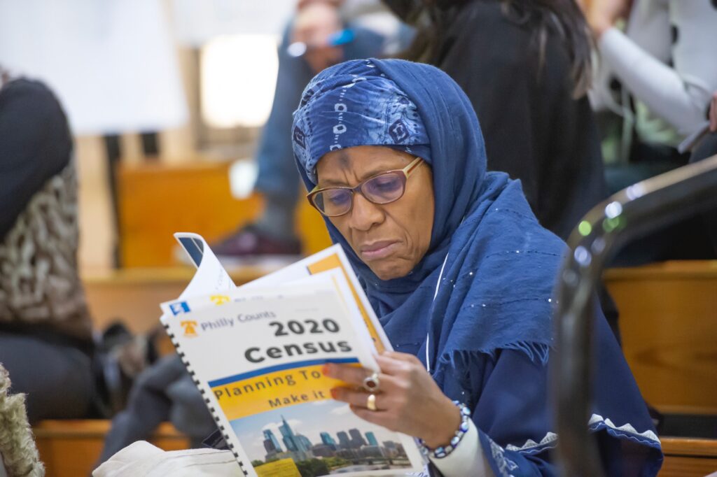 2019 11 08-j wilson-south philadelphia high school-philly counts census Ruqayya Ali of Center City peruses Philly Counts census literature during the Philly Counts 2020 summit at South Philadelphia High School. (Jonathan Wilson for WHYY)