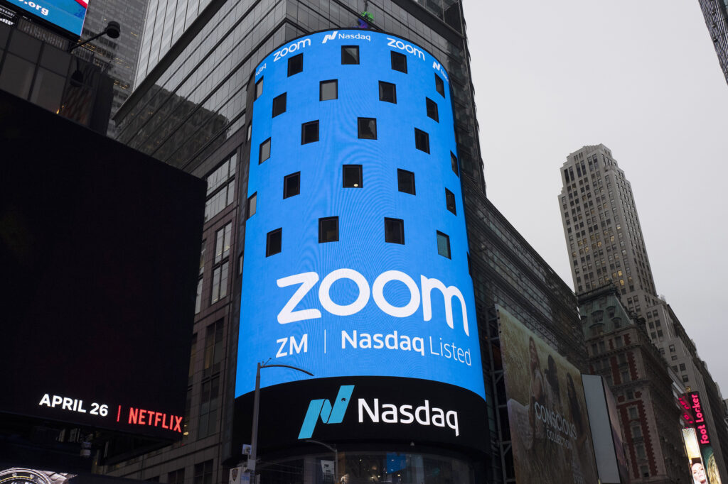 FILE - In this April 18, 2019, file photo shows a sign for Zoom Video Communications ahead Nasdaq IPO in New York.  (AP Photo/Mark Lennihan, File)