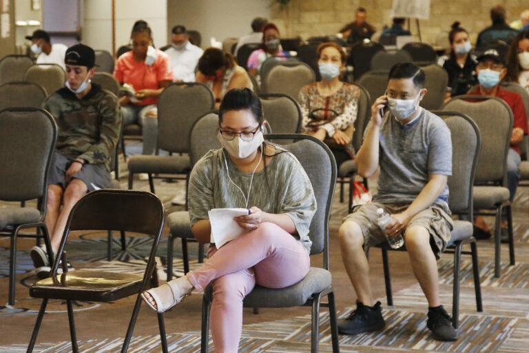 People wait to speak with representatives from the Oklahoma Employment Security Commission about unemployment claims