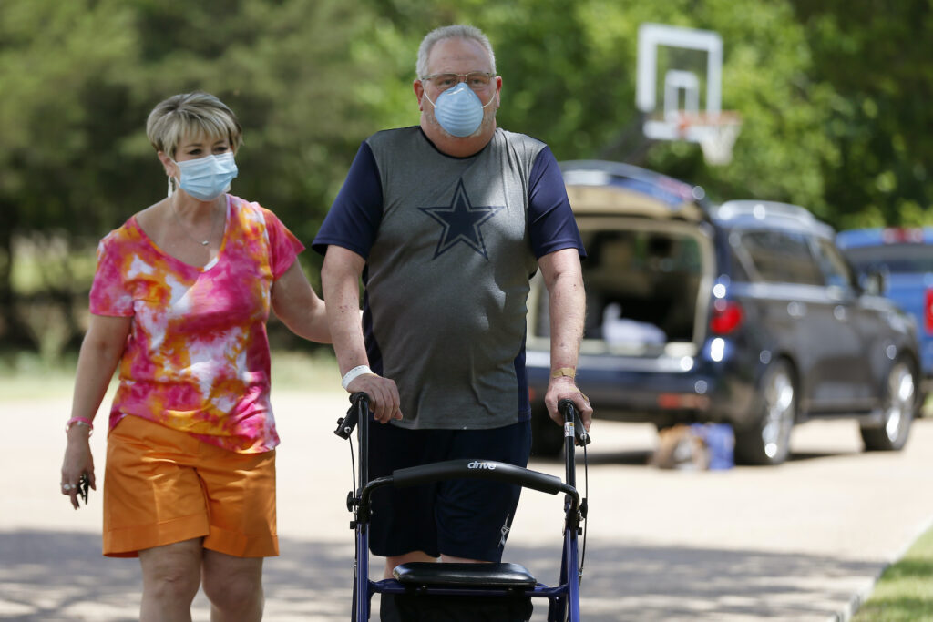 Stephen Donelson, Terri Donelson Terri Donelson, left, and her husband, Stephen, walk up their driveway to see friends and family awaiting him at his home in Midlothian, Texas on Friday, June 19, 2020, after his 90-day stay in the Zale Hospital on the UT Southwestern Campus. (AP Photo/Tony Gutierrez)