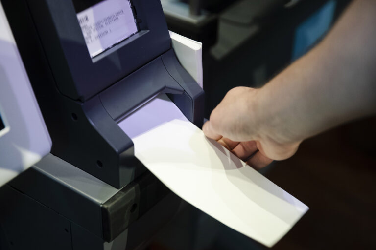 In this June 13, 2019 file photo, an Investigator with the Office of the City Commissioners, demonstrates the ExpressVote XL voting machine at the Reading Terminal Market in Philadelphia. (AP Photo/Matt Rourke)