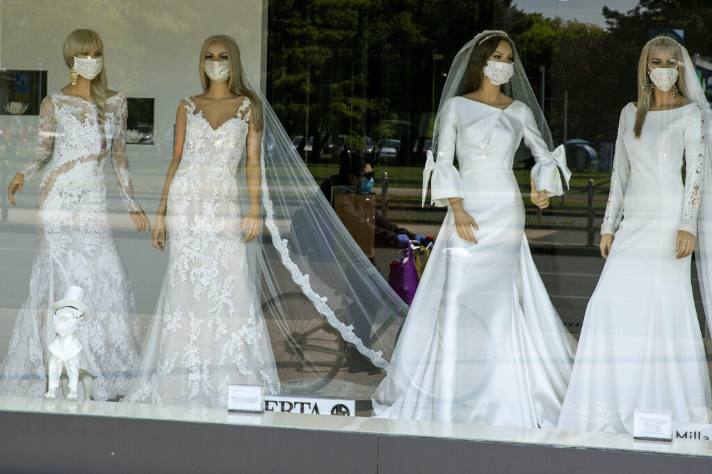 Virus Outbreak-No-Mask Weddings A cyclist wearing a coronavirus protective mask is reflected in a wedding dresses store window where mannequins also wear masks, in Zagreb, Croatia, Thursday, April 23, 2020. The store is closed because of Covid-19 lockdown. (AP Photo/Darko Bandic)