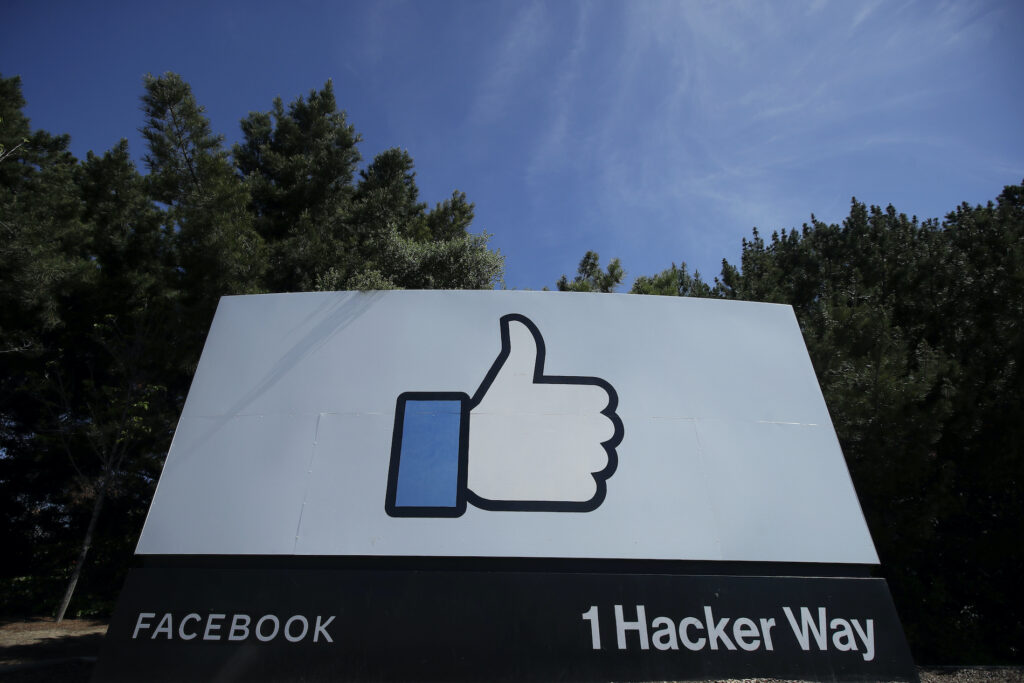 Facebook-Trump-Deleted Post The thumbs up Like logo is shown on a sign at Facebook headquarters in Menlo Park, Calif., Tuesday, April 14, 2020. (AP Photo/Jeff Chiu)