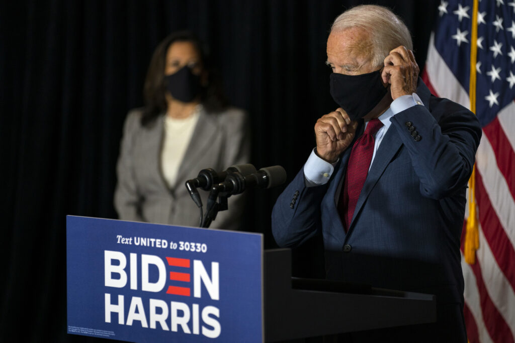 Joe Biden, Kamala Harris Democratic presidential candidate former Vice President Joe Biden joined by his running mate Sen. Kamala Harris, D-Calif., replaces his face mask after speaking at the Hotel DuPont in Wilmington, Del., Thursday, Aug. 13, 2020. (AP Photo/Carolyn Kaster)