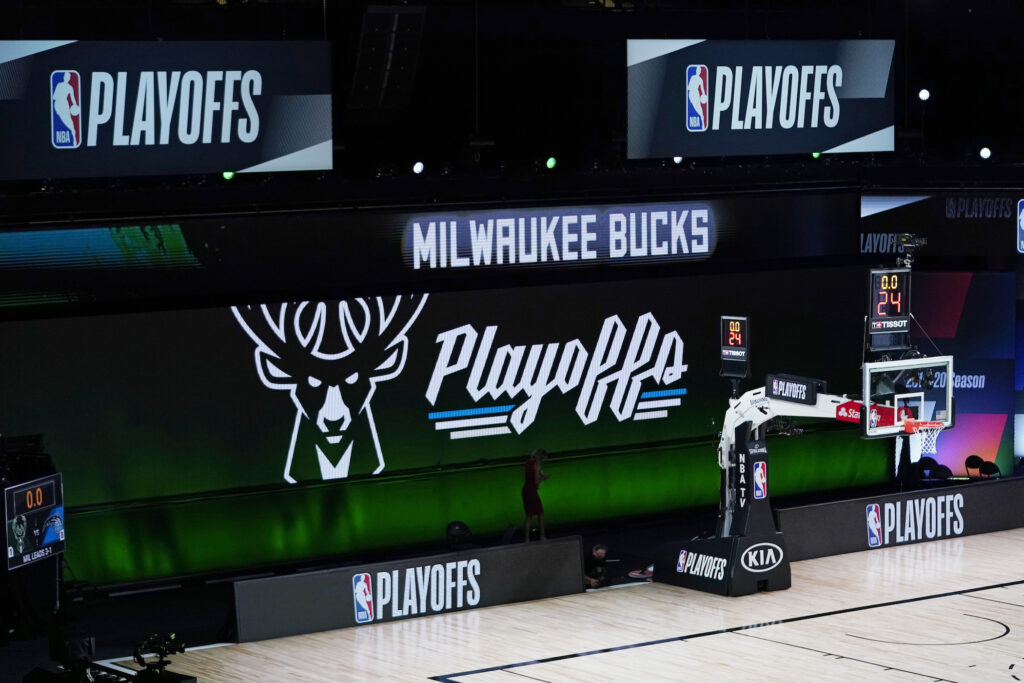 Magic Bucks Basketball Milwaukee Bucks signage is displayed on screens beside an empty court before the scheduled start of an NBA basketball first round playoff game between the Milwaukee Bucks and the Orlando Magic, Wednesday, Aug. 26, 2020, in Lake Buena Vista, Fla. (AP Photo/Ashley Landis, Pool)