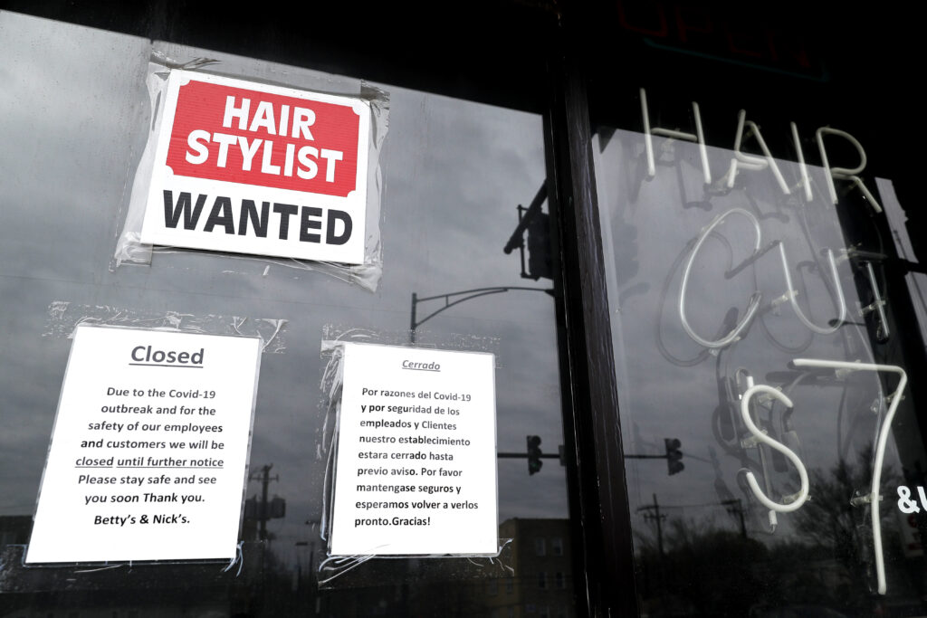 Unemployment Benefits In this April 30 ,2020 file photo, a barber shop shows closed and hiring sign during the COVID-19 in Chicago. On Thursday, Aug. 27, just over 1 million Americans applied for unemployment benefits last week, a sign that the coronavirus outbreak continues to threaten jobs even as the housing market, auto sales and other segments of the economy rebound from a springtime collapse. (AP Photo/Nam Y. Huh, File)