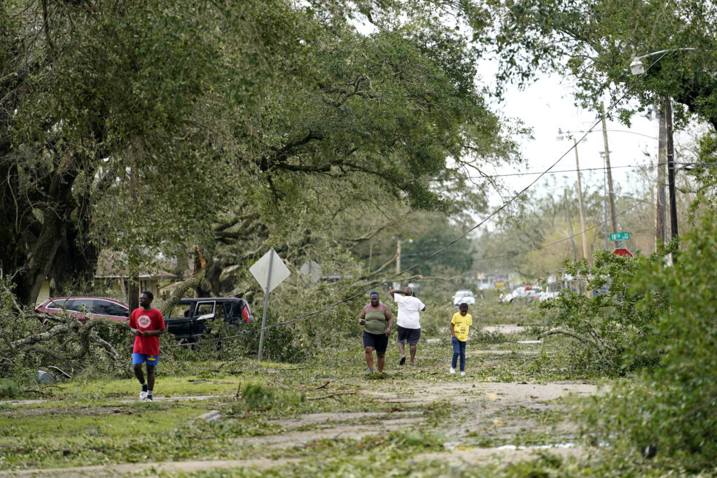 APTOPIX Tropical Weather Louisiana People survey the damage to their neighborhood on Thursday, Aug. 27, 2020, in Lake Charles, La., in the aftermath of Hurricane Laura. (AP Photo/Gerald Herbert)