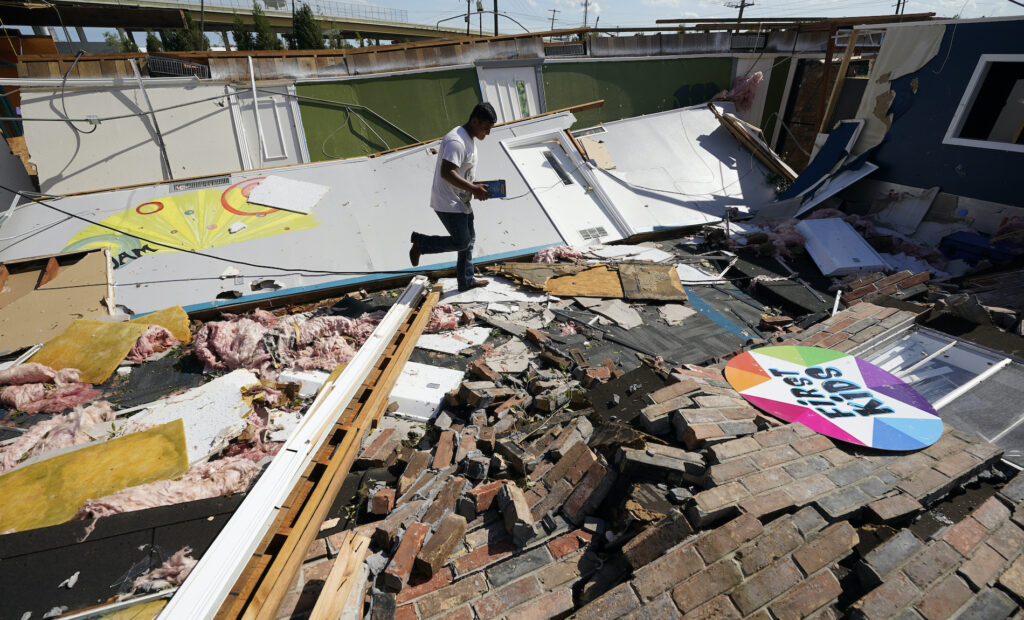 Benjamin Luna Benjamin Luna helps recover items from the children's wing of the First Pentecostal Church that was destroyed by Hurricane Laura, Thursday, Aug. 27, 2020, in Orange, Texas. (AP Photo/Eric Gay)