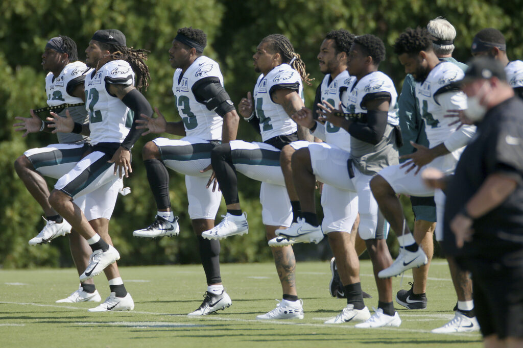 Philadelphia Eagles defenders warm up during NFL training camp Philadelphia Eagles defenders warm up during NFL training camp