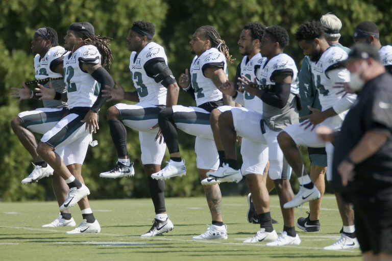 Philadelphia Eagles defenders warm up during NFL training camp
