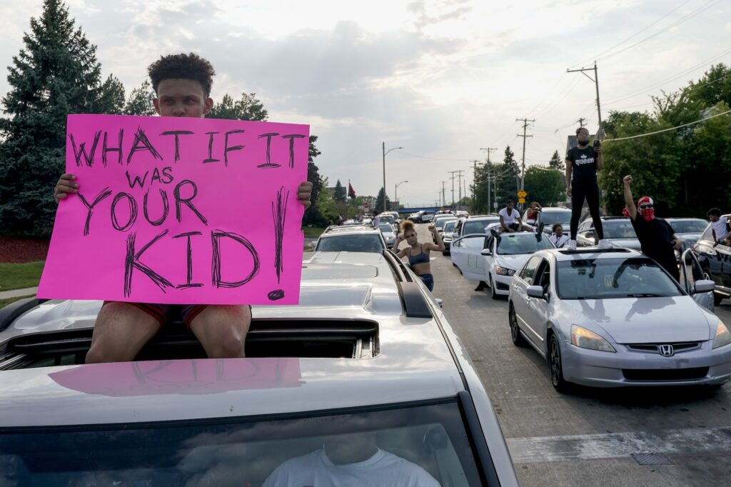 AP_jacob_blake_protest_082520 A protester sits on a car