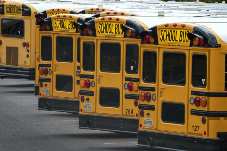 Fairfax County Public School buses are lined up at a maintenance facility