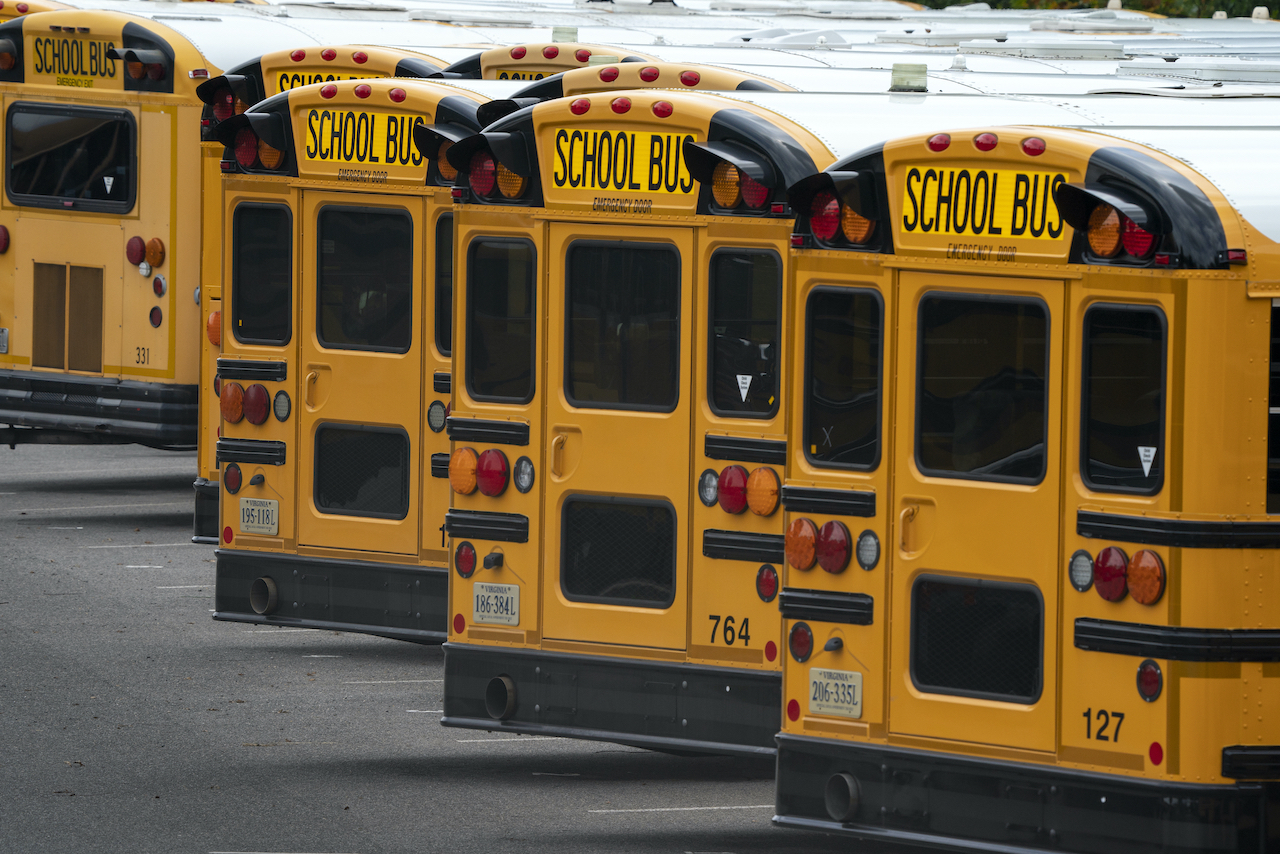 Fairfax County Public School buses are lined up at a maintenance facility