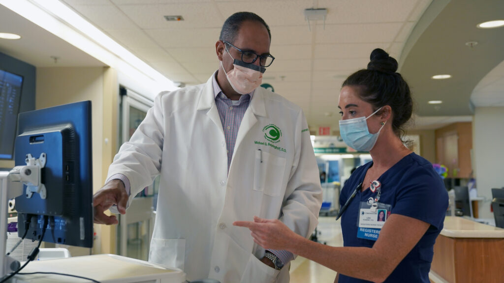Dr-Benninghoff-and-RN-Lea-Robbins2 Dr. Mike Benninghoff confers with registered nurse Lea Robbins in Christiana Hospital's intensive care unit for COVID-19 patients. (Courtesy of ChristianaCare)